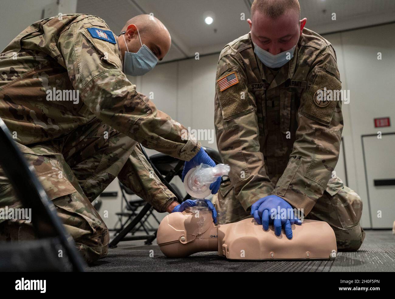 New York Guardsman Joshue Batista, assigned to the 88th Brigade Headquarters, and U.S. Army 1st Lt. Jack Stapleton, assigned to A Co. 1st Battalion 69th Infantry Regiment, 27th Infantry Brigade Combat Team, 42nd Infantry Division, receive a class on Cardiopulmonary resuscitation, which is an emergency procedure that combines chest compressions often with artificial ventilation to manually preserve intact brain function until further measures are taken to restore spontaneous blood circulation and breathing in a person who is in cardiac arrest, from Empress Emergency Medical Services, in support Stock Photo