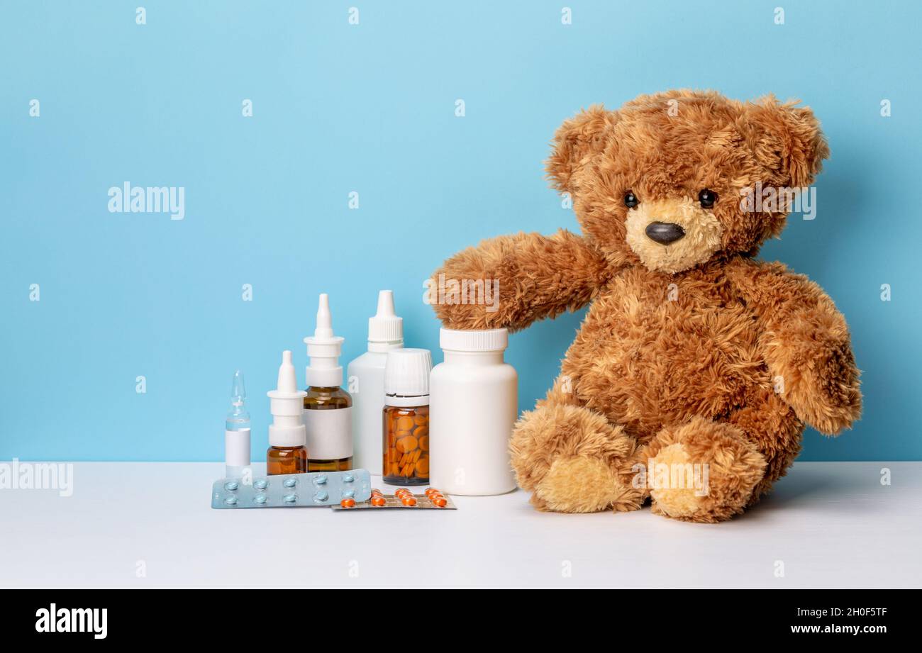 Baby Medicine. Teddy bear and jars of pills and spray, medicines for ...