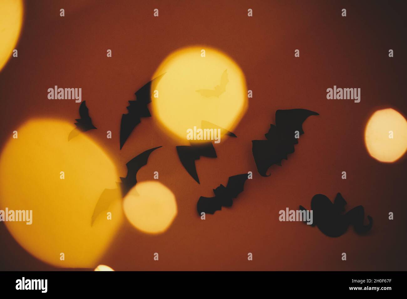 Happy Halloween. Bats flying on dark orange background with magical ...