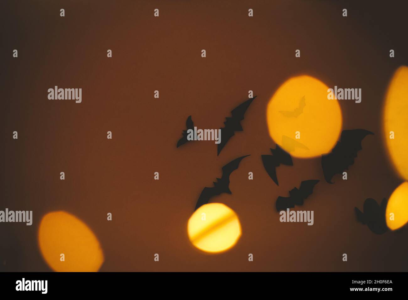 Halloween background. Bats flying on dark orange background with ...