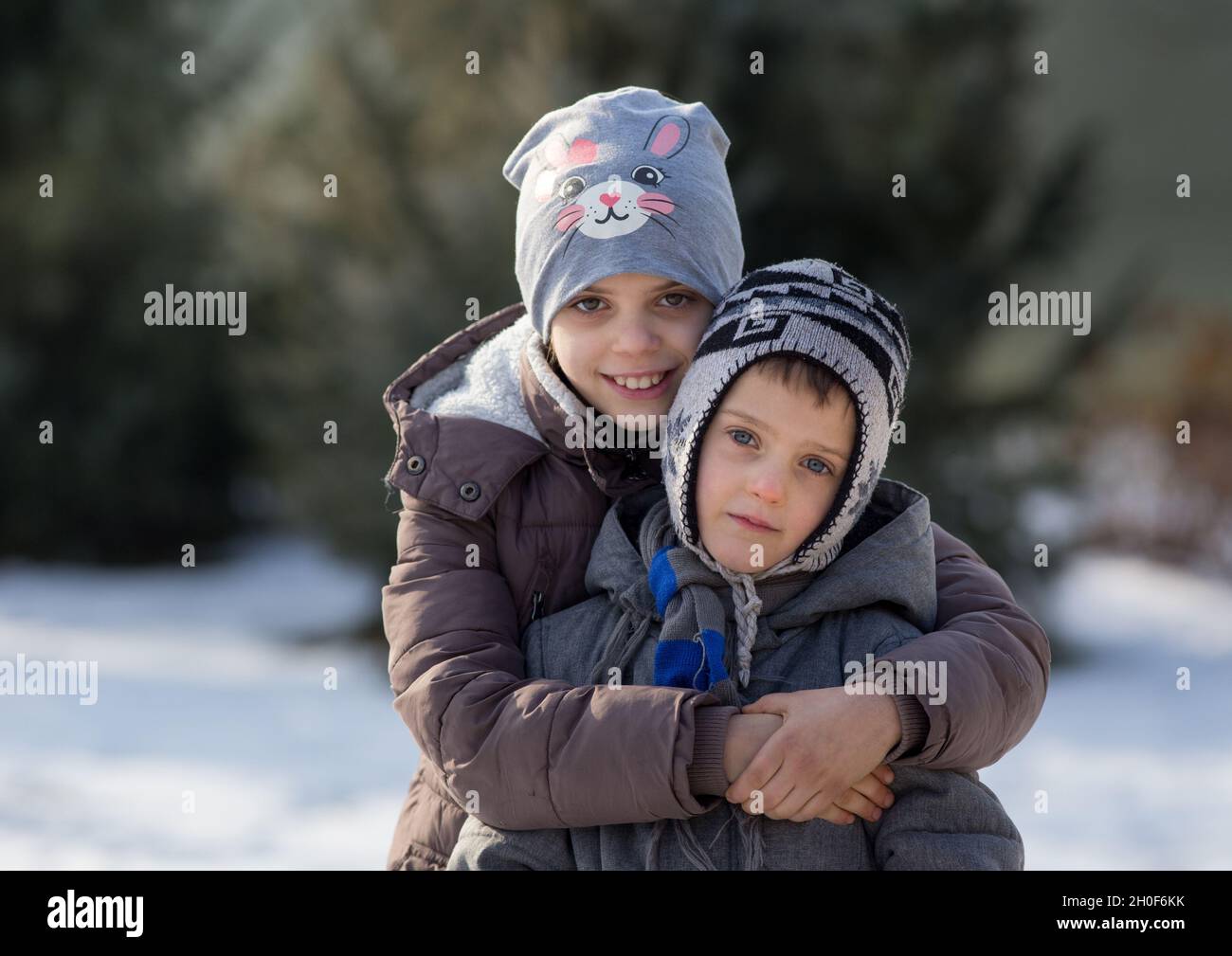 Brother and sister playing in snow hi-res stock photography and images ...