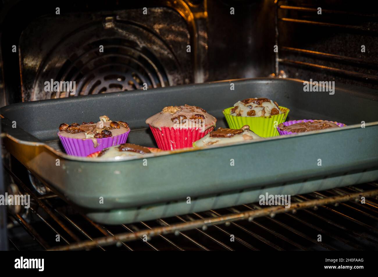 muffin in colorful shapes in the oven Stock Photo