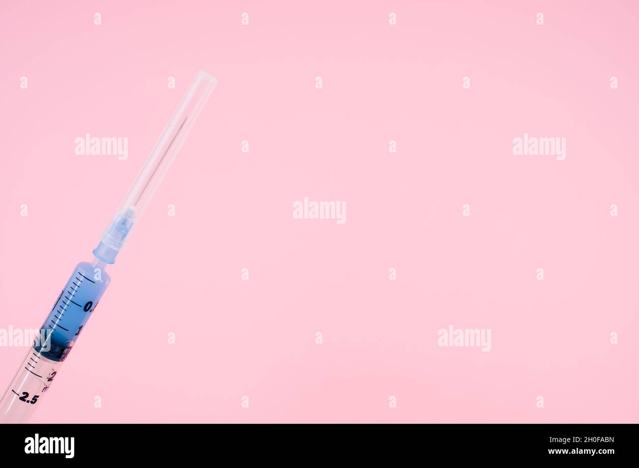 sterilized injection syringe on a pink background Stock Photo - Alamy