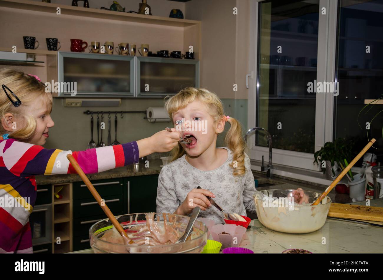 Two Kids Preparing Sweet Muffins In The Kitchen Stock Photo Alamy two-kids-preparing-sweet-muffins-in-the-kitchen-stock-photo-alamy