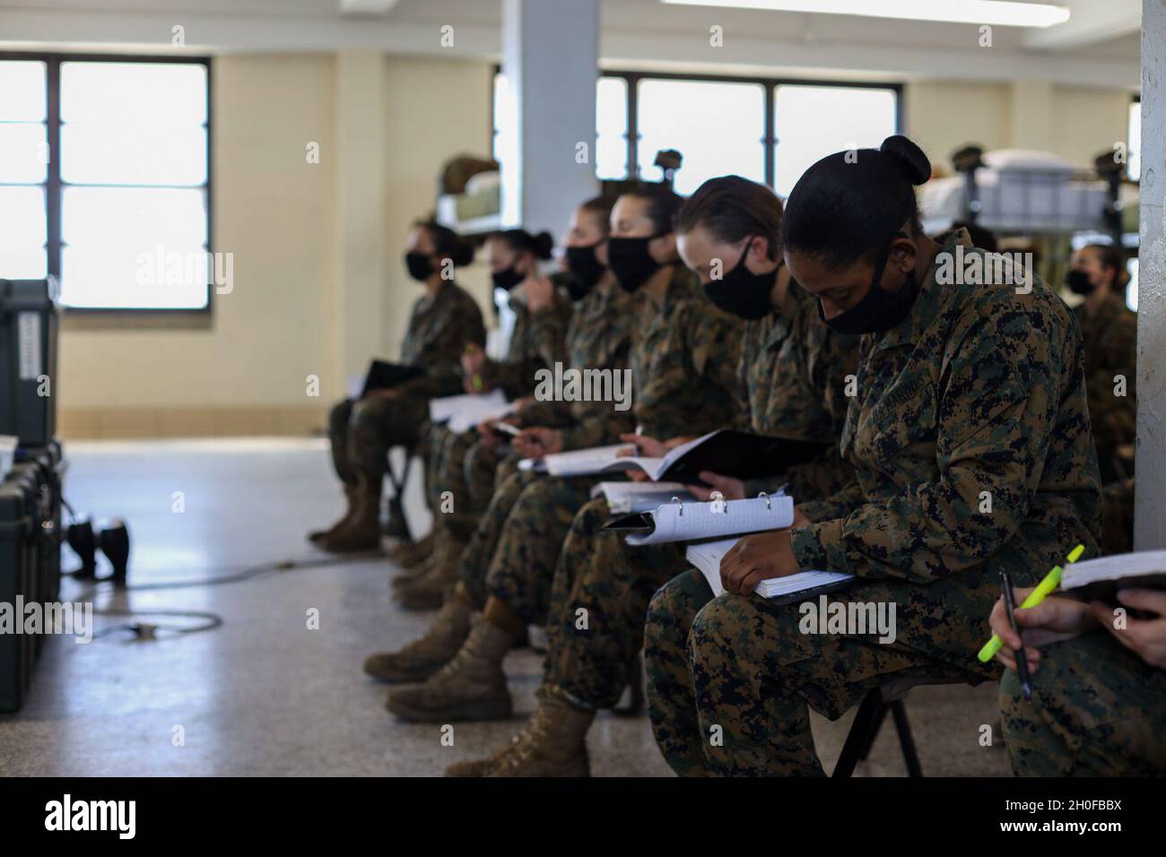Recruits with Oscar Company, 4th Recruit Training Battalion, listen to a class on Marine Corps Recruit Depot Parris Island, S.C. Feb. 24, 2021. Recruits take classes to prepare for final testing which is a graduation requirement. Stock Photo