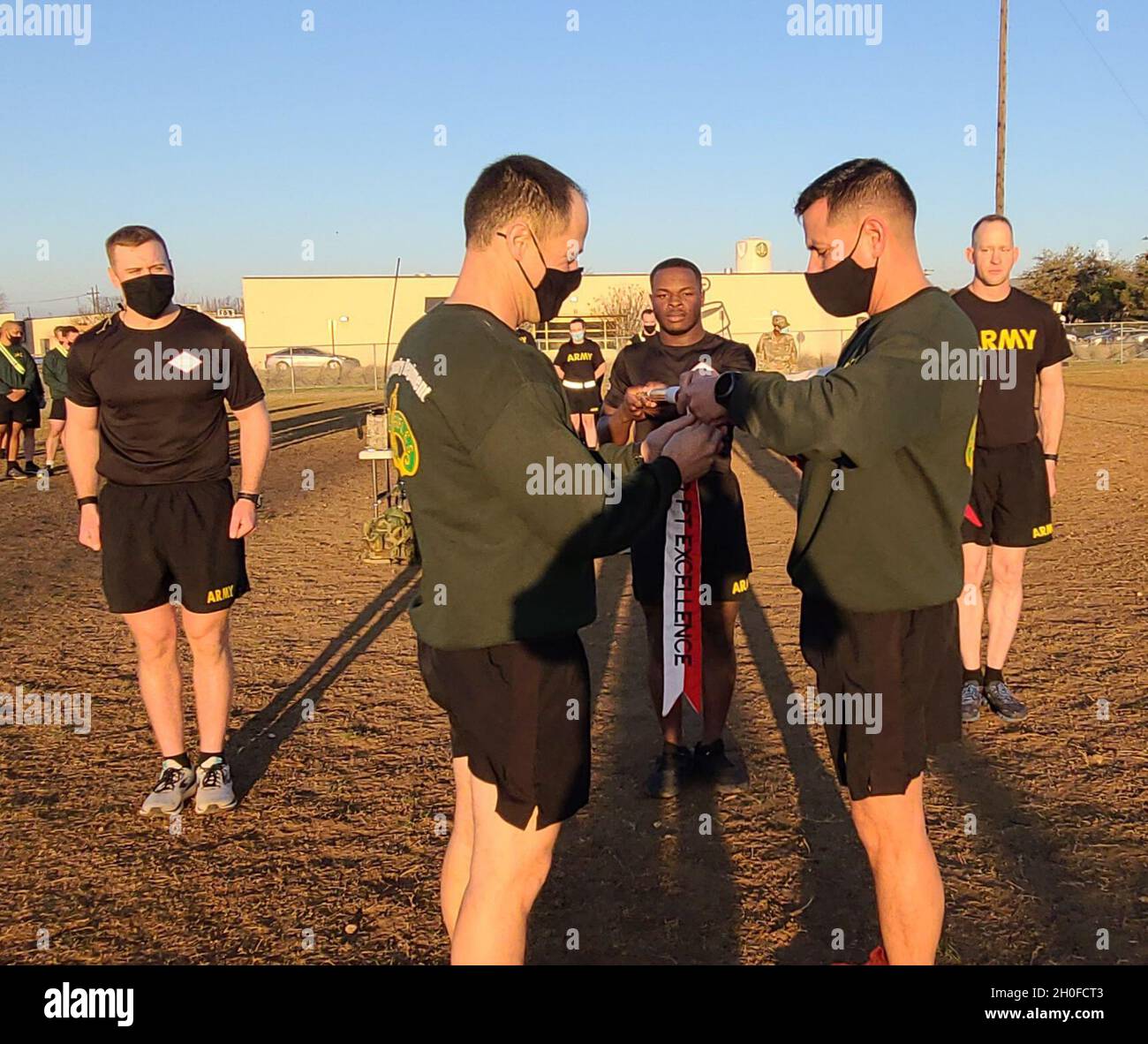 3rd Cavalry Regiment Commander, Col. Kevin Bradley and Command Sgt. Maj. Shade Munday present Eagle Troop, 2nd Squadron with the RCO PT Excellence Streamer following the Troops Rifles Challenge win. Stock Photo