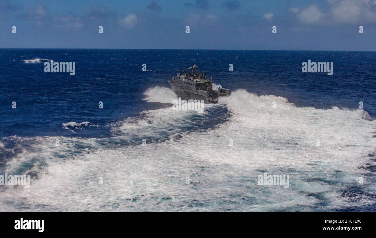 A U.S. Navy Mark VI patrol boat with Maritime Expeditionary Security Squadron Two, Bravo Company, navigates away after a refueling aboard dock landing ship USS Ashland (LSD 48) in the Philippine Sea, Feb. 25, 2021. The 31st MEU is operating aboard ships of the Amphibious Squadron 11 in the 7th fleet area of operations to enhance interoperability with allies and partners and serve as a ready response force to defend peace and stability in the Indo-Pacific Region. Stock Photo