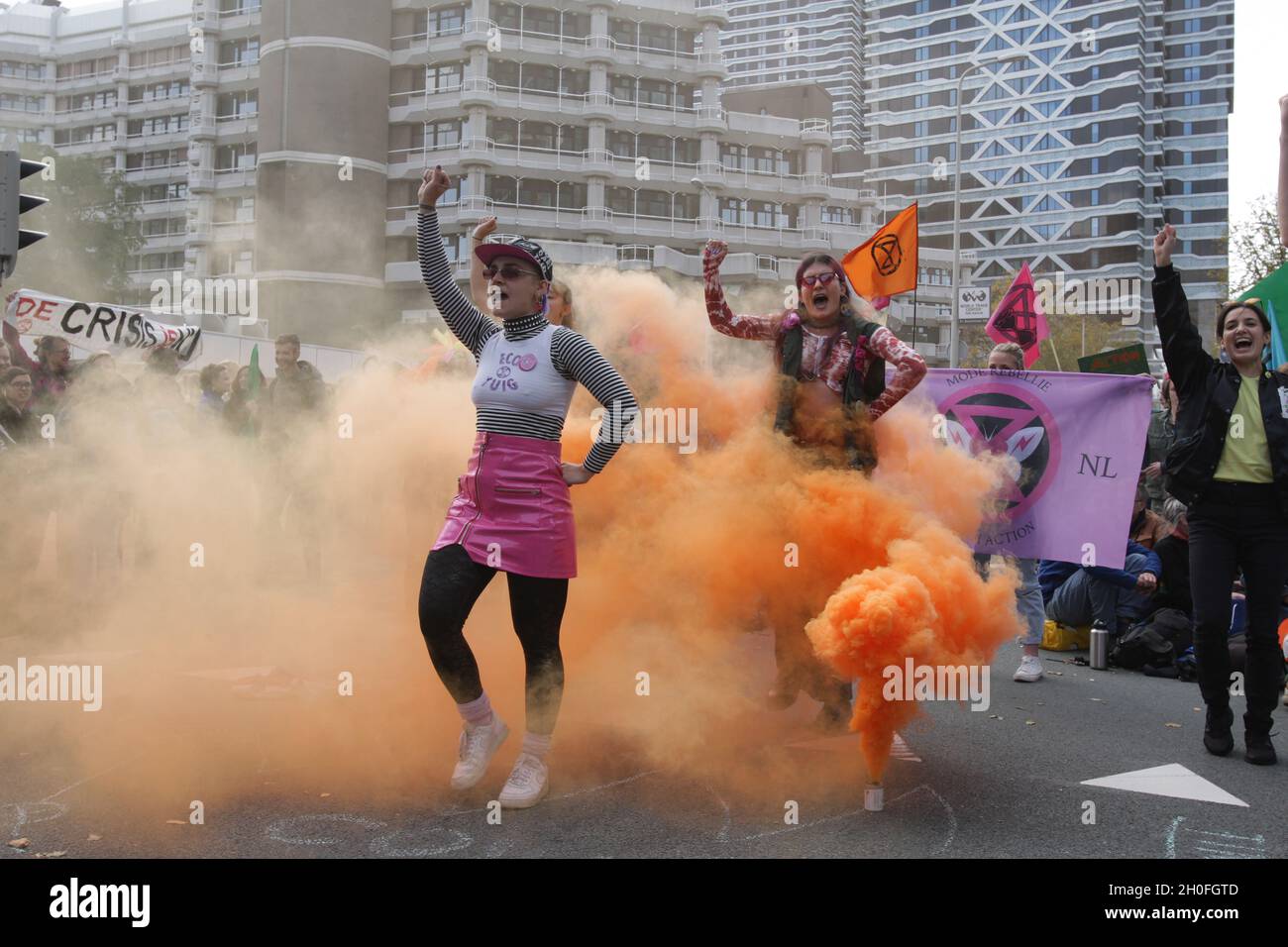 Extinction Rebellion climate activists perform with smoke block the road during protest  in front of the Ministry of Economic Affairs and Climate on O Stock Photo