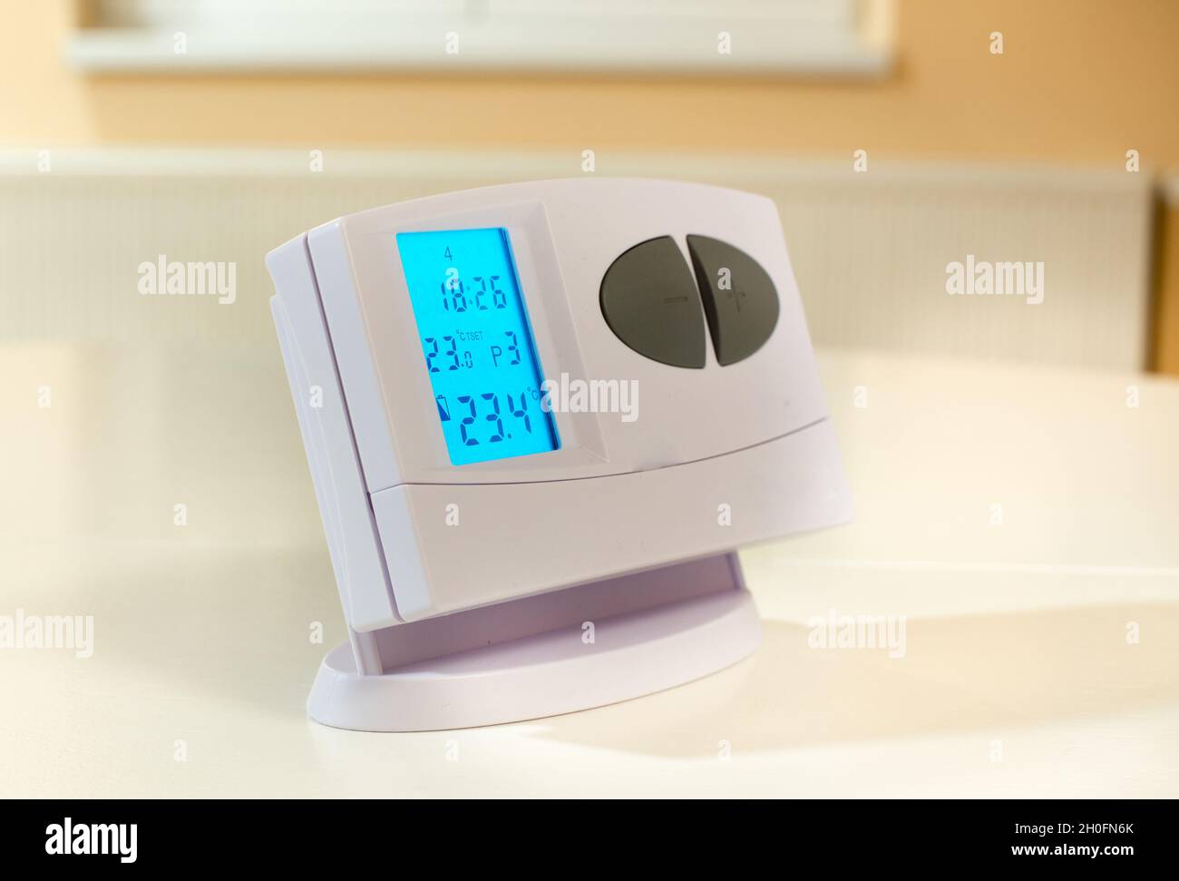 Close up of heat control device in front of radiator. Central heating