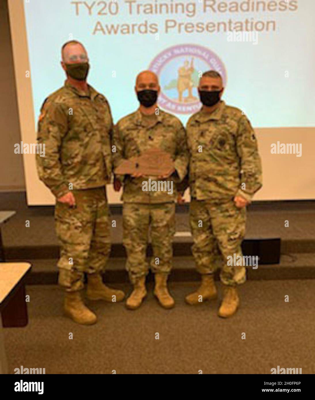 Brig. Gen. Robert Larkin awards the top battalion for training year 2020 in overall training readiness to the 2nd Battalion, 138th Field Artillery’s commander, Lt. Col. Michael Woodson and Command Sgt. Maj. David Page. Stock Photo