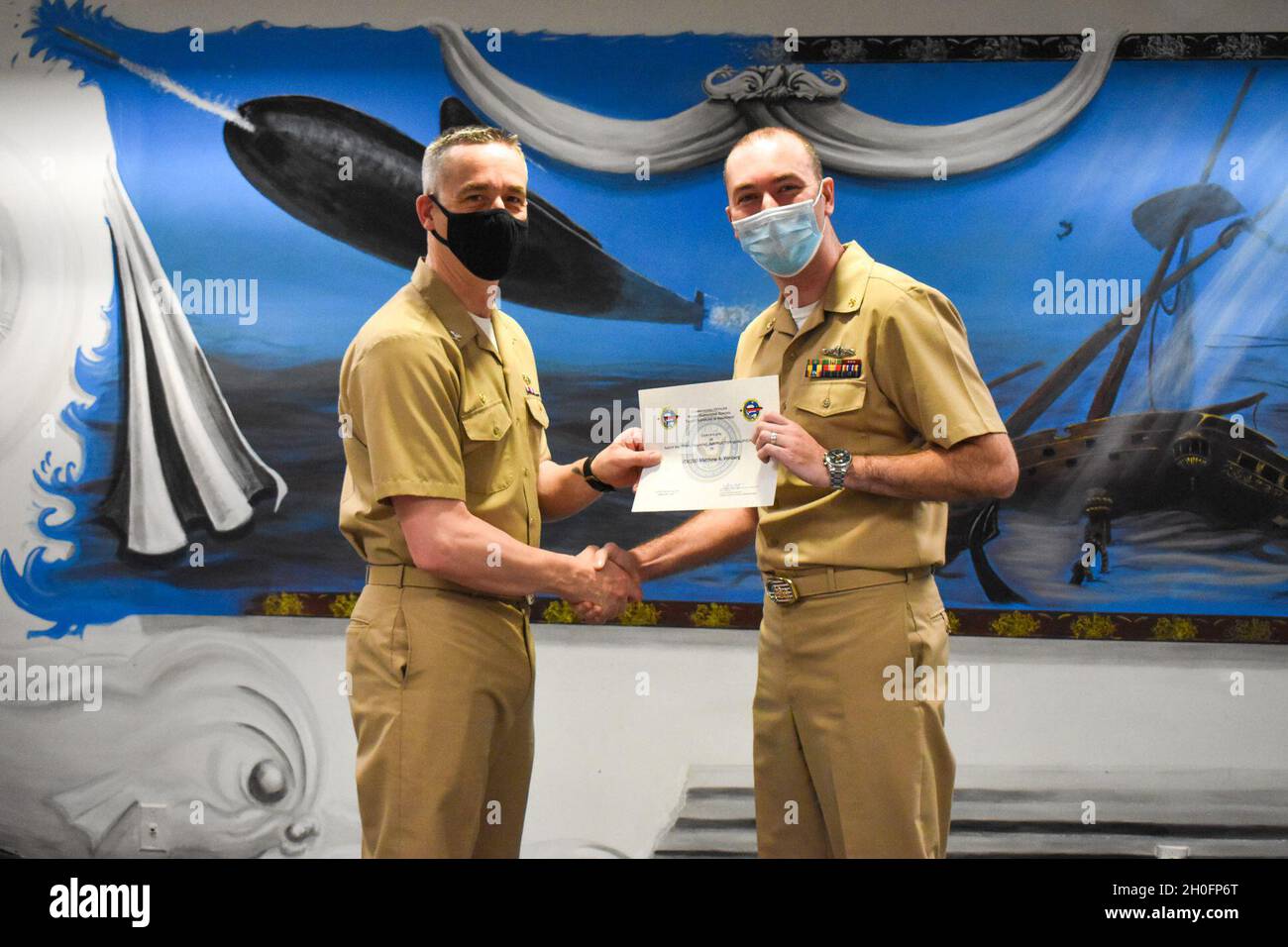 Captain Steven Antcliff, Commanding Officer, Naval Submarine School, awards Chief Information