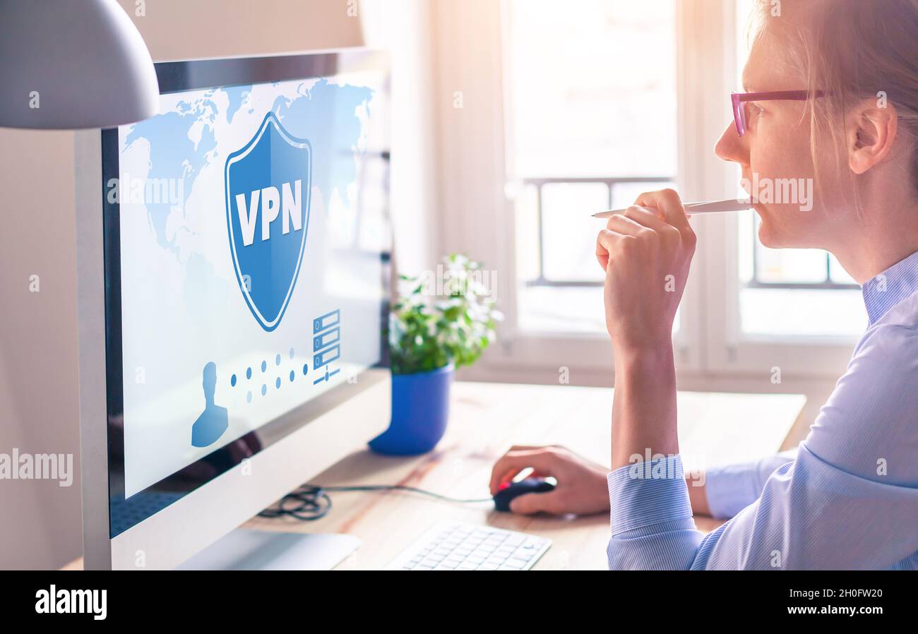 VPN secure connection for freelancer Person using Virtual Private Network technology on computer to create encrypted tunnel to remote server on intern Stock Photo