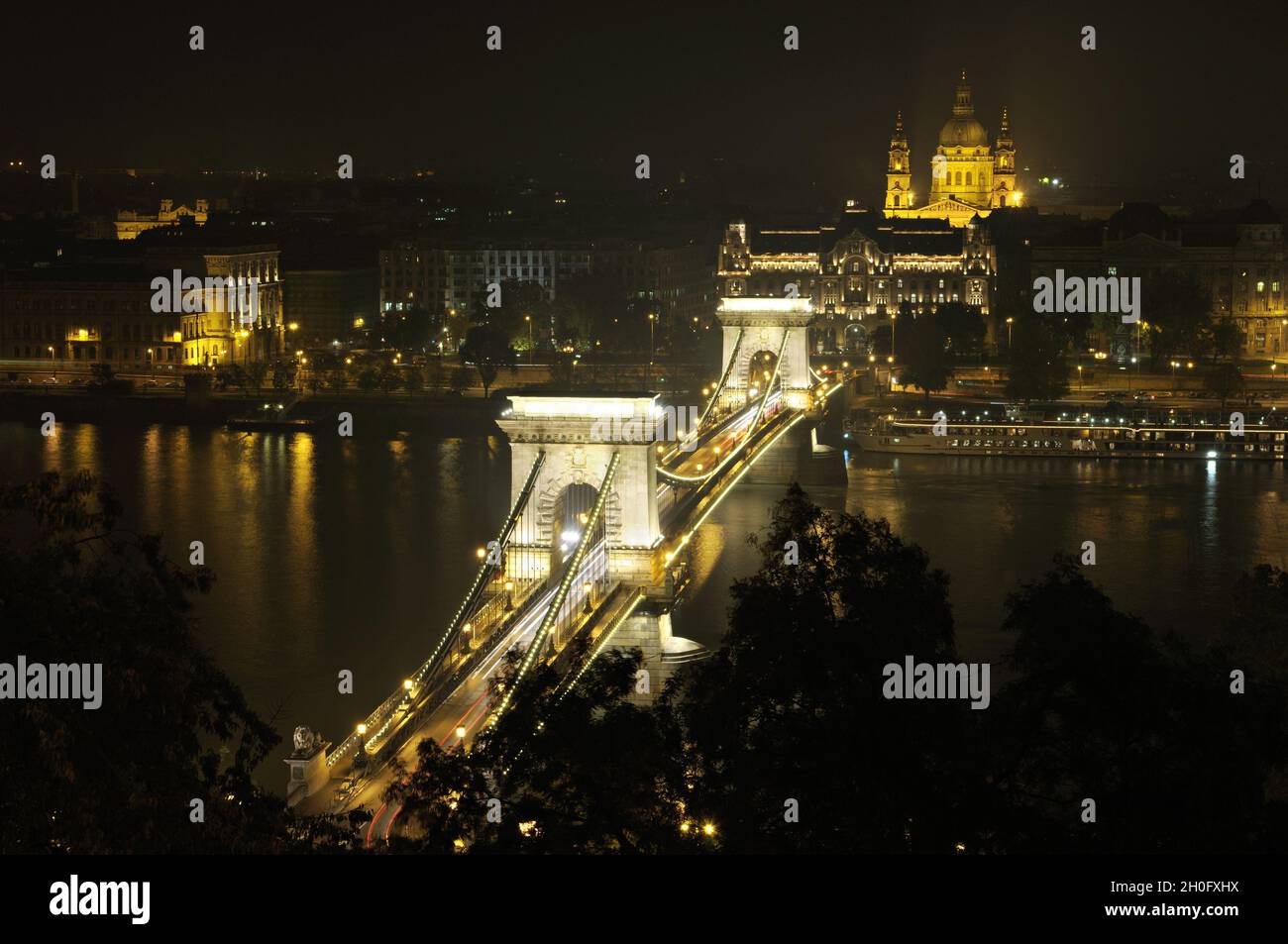 Szechenyi Chain Bridge in front of St Stephen's Basilica at night in Budapest, Hungary Stock Photo