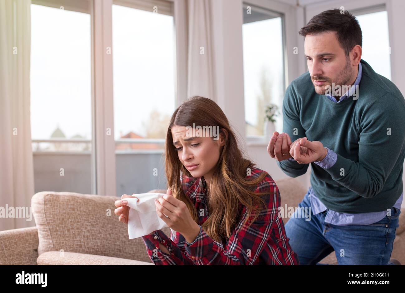 Young couple having fight at home. Girl crying and man explaining ...