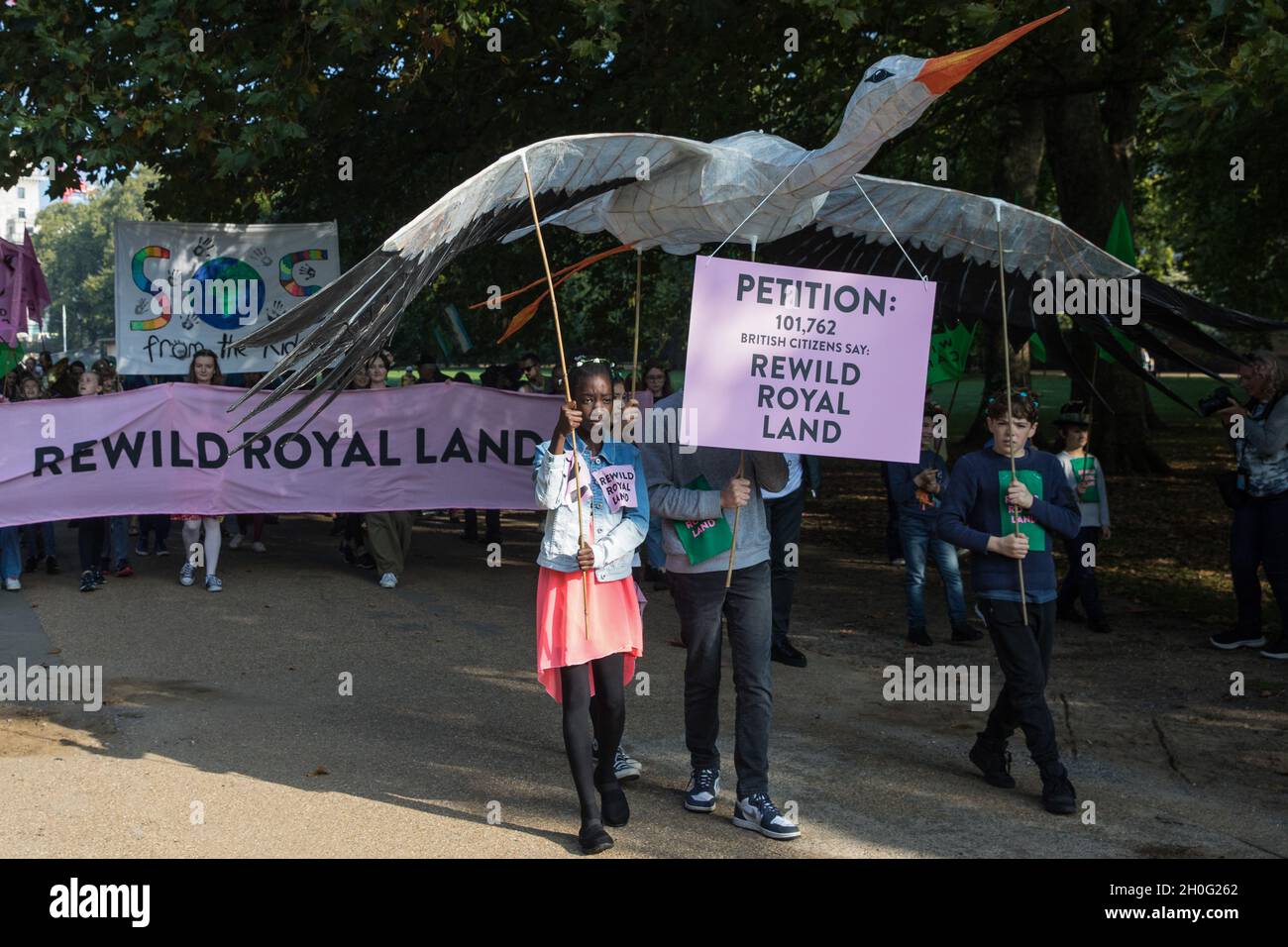 London, UK. 9th October, 2021. Climate activists, including many families, take part in a Rewild Royal Land procession to Buckingham Palace organised by Wild Card, a new campaign calling on the UK’s biggest landowners to rewild, and 38 Degrees. Campaigners including conservationist and broadcaster Chris Packham are calling on the Royal Family, the largest landowning family in the UK, to rewild their estates in order to assist with tackling the climate crisis and a 14-year-old boy presented a petition at the gates of Buckingham Palace signed by over 100,000 people. Credit: Mark Kerrison/Alamy L Stock Photo
