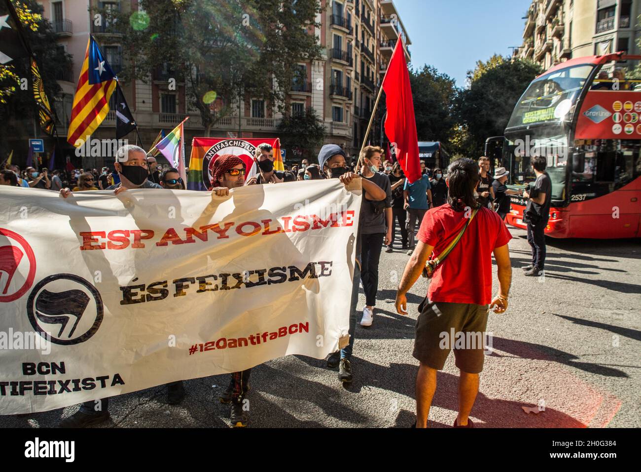 Barcelona, Spain. 12th Oct, 2021. Protesters hold a banner and flags during the demonstration.People from anti-fascist groups have called a demonstration against the events of October 12, Hispanic Day in Barcelona. The protesters have gone in the direction of some of these acts but the police have prevented them on all occasions. Credit: SOPA Images Limited/Alamy Live News Stock Photo