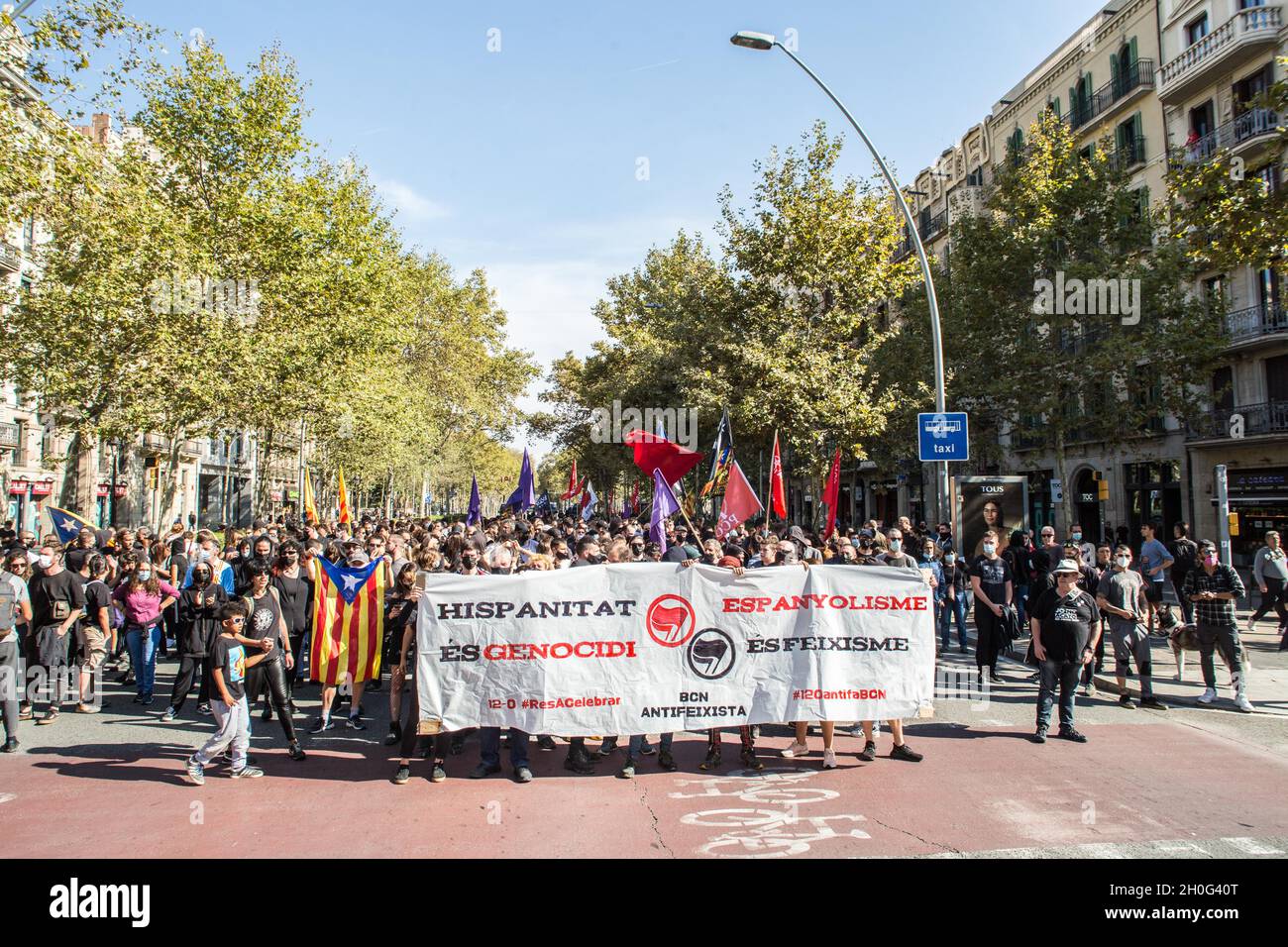 Barcelona, Spain. 12th Oct, 2021. Protesters march through the streets while holding a banner during the demonstration.People from anti-fascist groups have called a demonstration against the events of October 12, Hispanic Day in Barcelona. The protesters have gone in the direction of some of these acts but the police have prevented them on all occasions. (Photo by Thiago Prudencio/SOPA Images/Sipa USA) Credit: Sipa USA/Alamy Live News Stock Photo