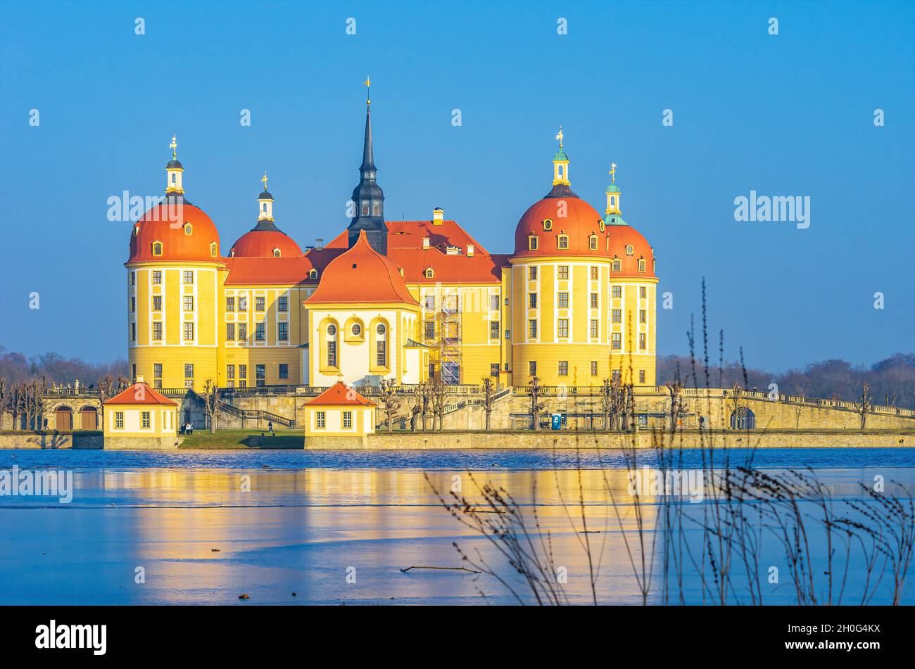 Moritzburg near Dresden, Saxony, Germany: Exterior view of Moritzburg Palace in winter with the palace pond half frozen over, from the West. Stock Photo