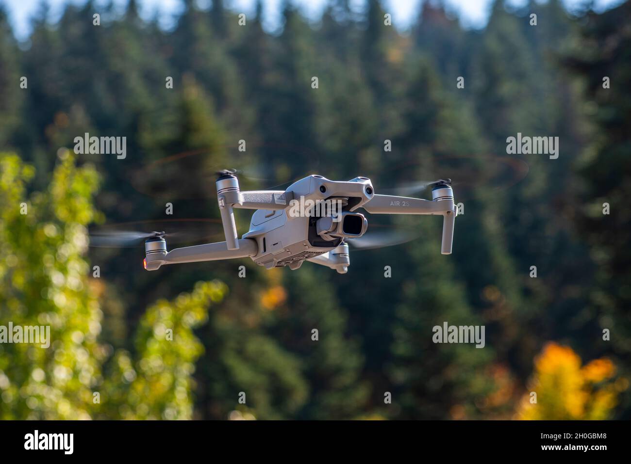 ISTANBUL, TURKEY - OCTOBER 11, 2021: DJI Air 2S Drone flying with green background. Stock Photo