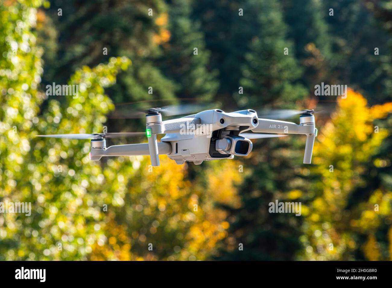 ISTANBUL, TURKEY - OCTOBER 11, 2021: DJI Air 2S Drone flying with green background. Stock Photo