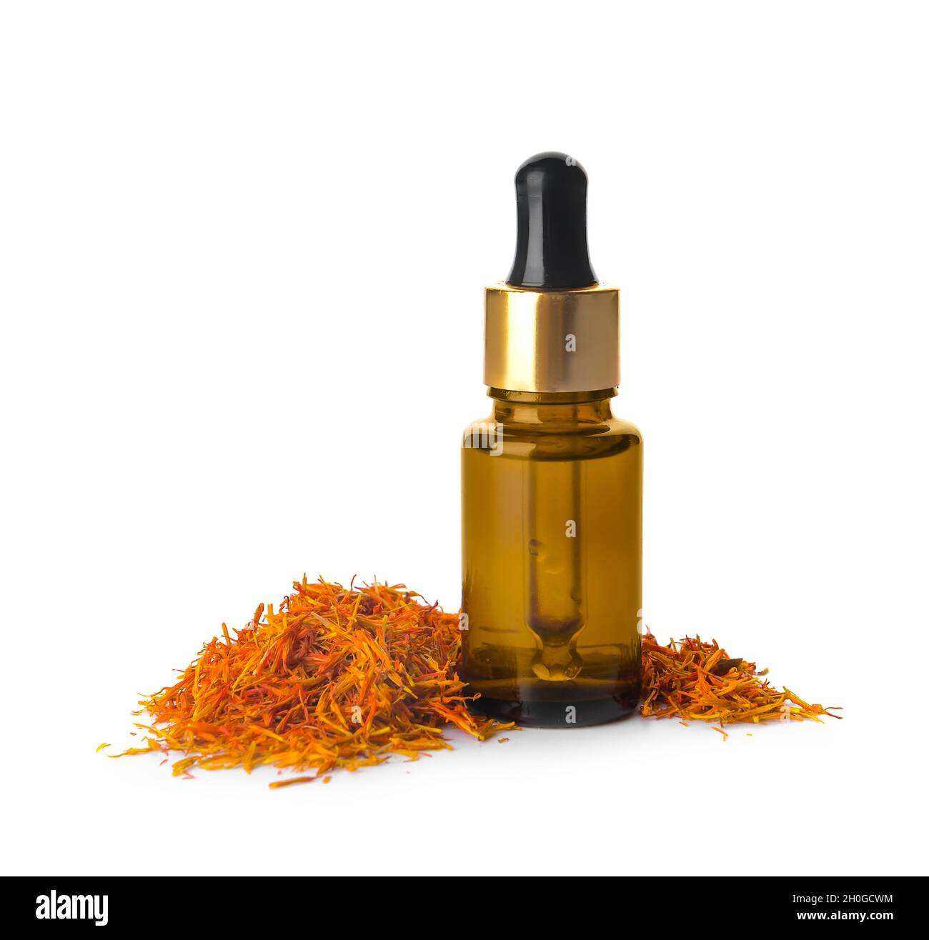 Bottle of saffron essential oil on white background Stock Photo Alamy