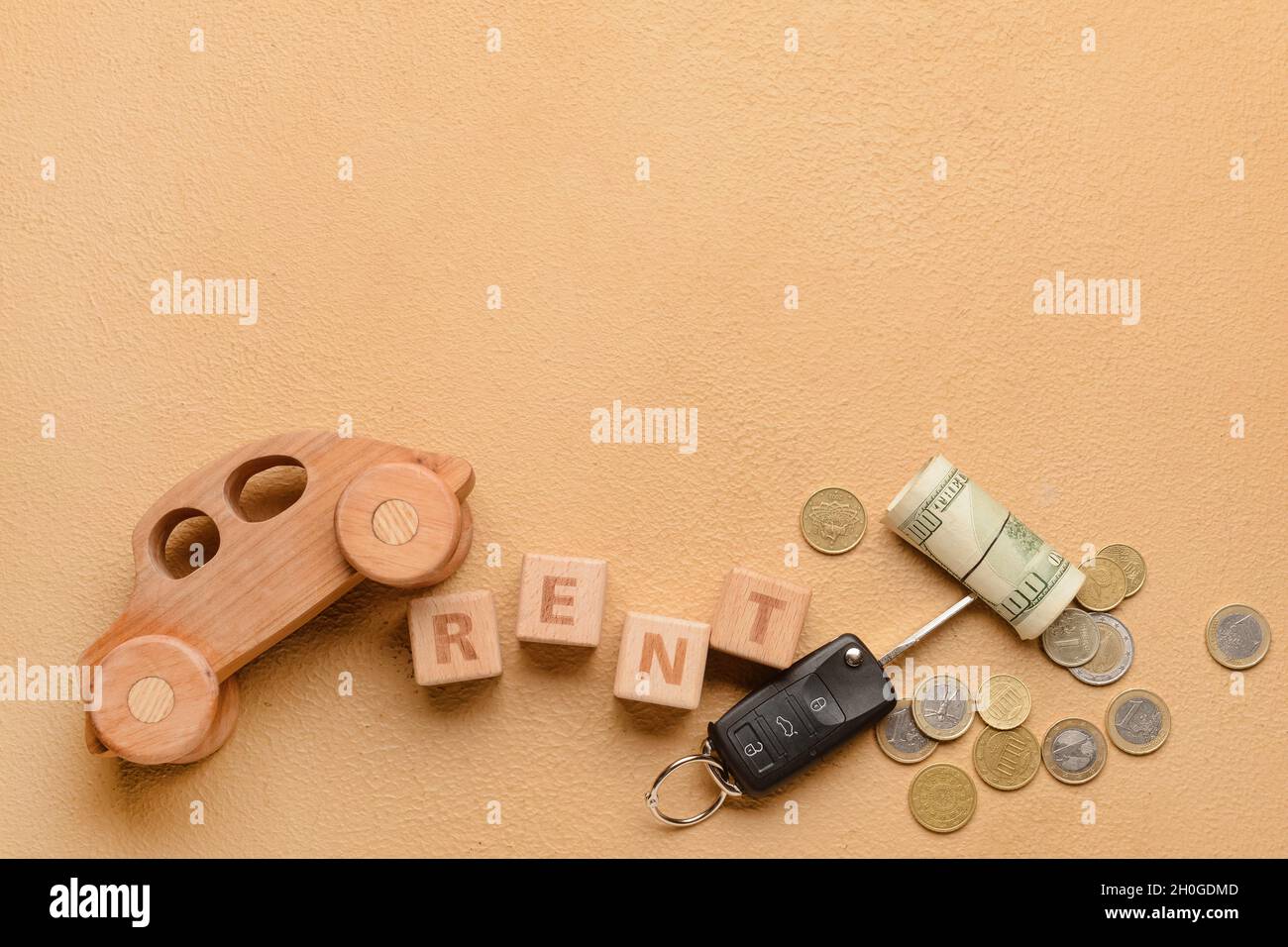 Word RENT with wooden car, key and money on beige background Stock ...