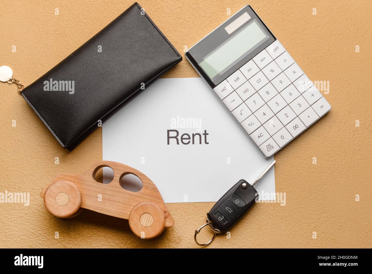 Background For Rent Paper Paper with word RENT, wooden car, wallet and calculator on beige ...