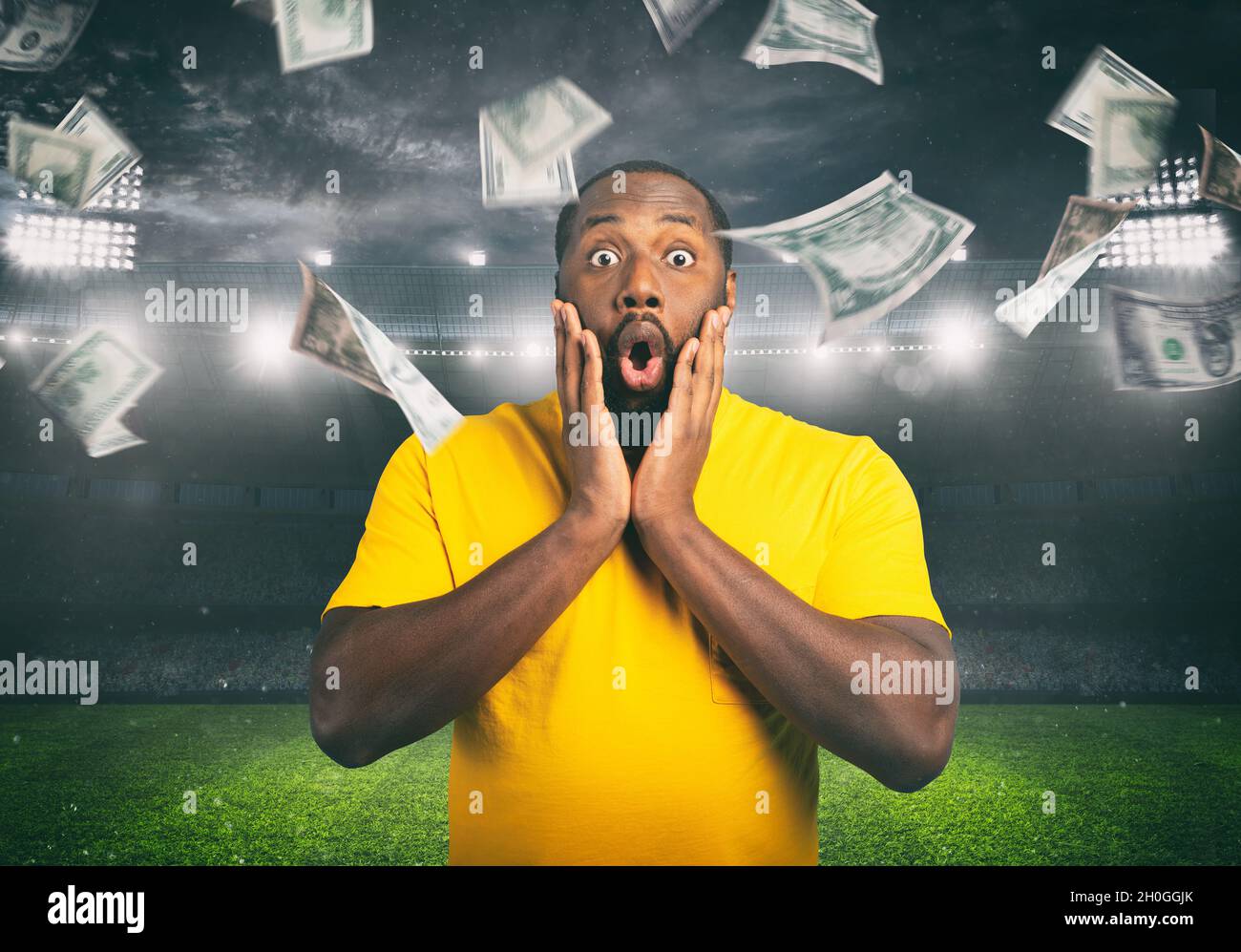 Astonished man for winning a sport bet. rain of money inside a soccer stadium Stock Photo