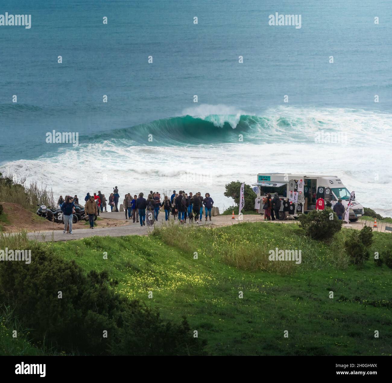 People Watching the Big Waves in Nazare - Nazare, Portugal Stock Photo