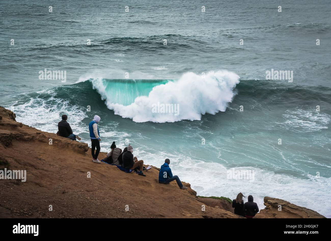 People Watching the Big Waves in Nazare - Nazare, Portugal Stock Photo