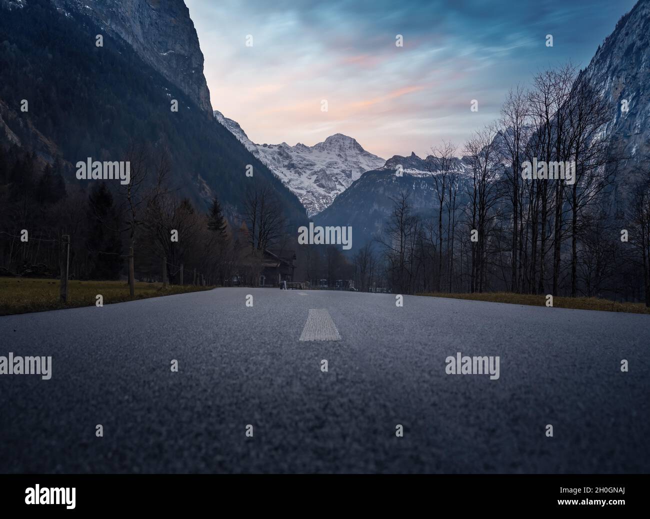 Road Low angle view of Bernese Alps Mountains at sunset - Lauterbrunnen, Switzerland Stock Photo