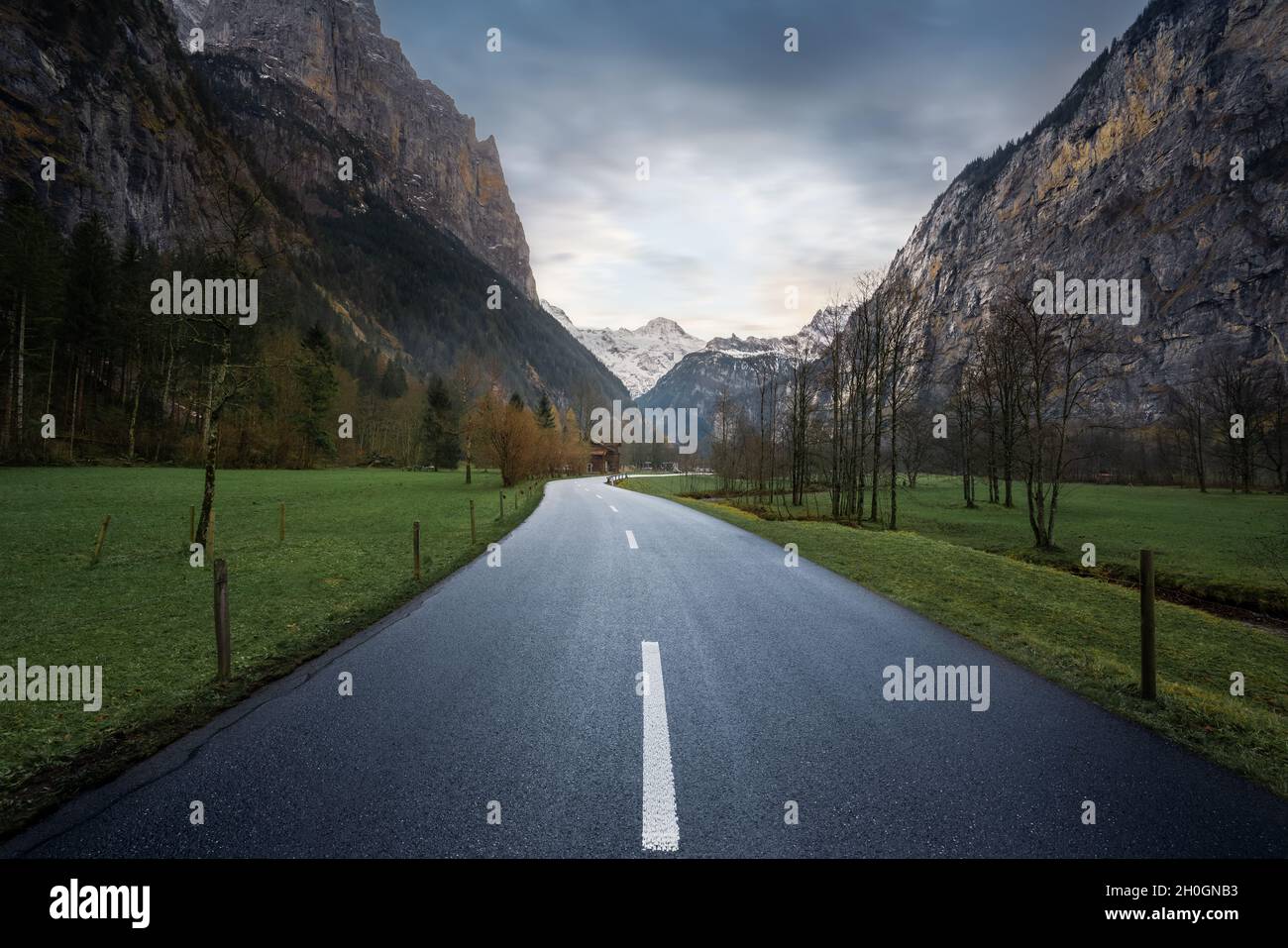 Road view leading straight into Bernese Alps Mountains - Lauterbrunnen, Switzerland Stock Photo