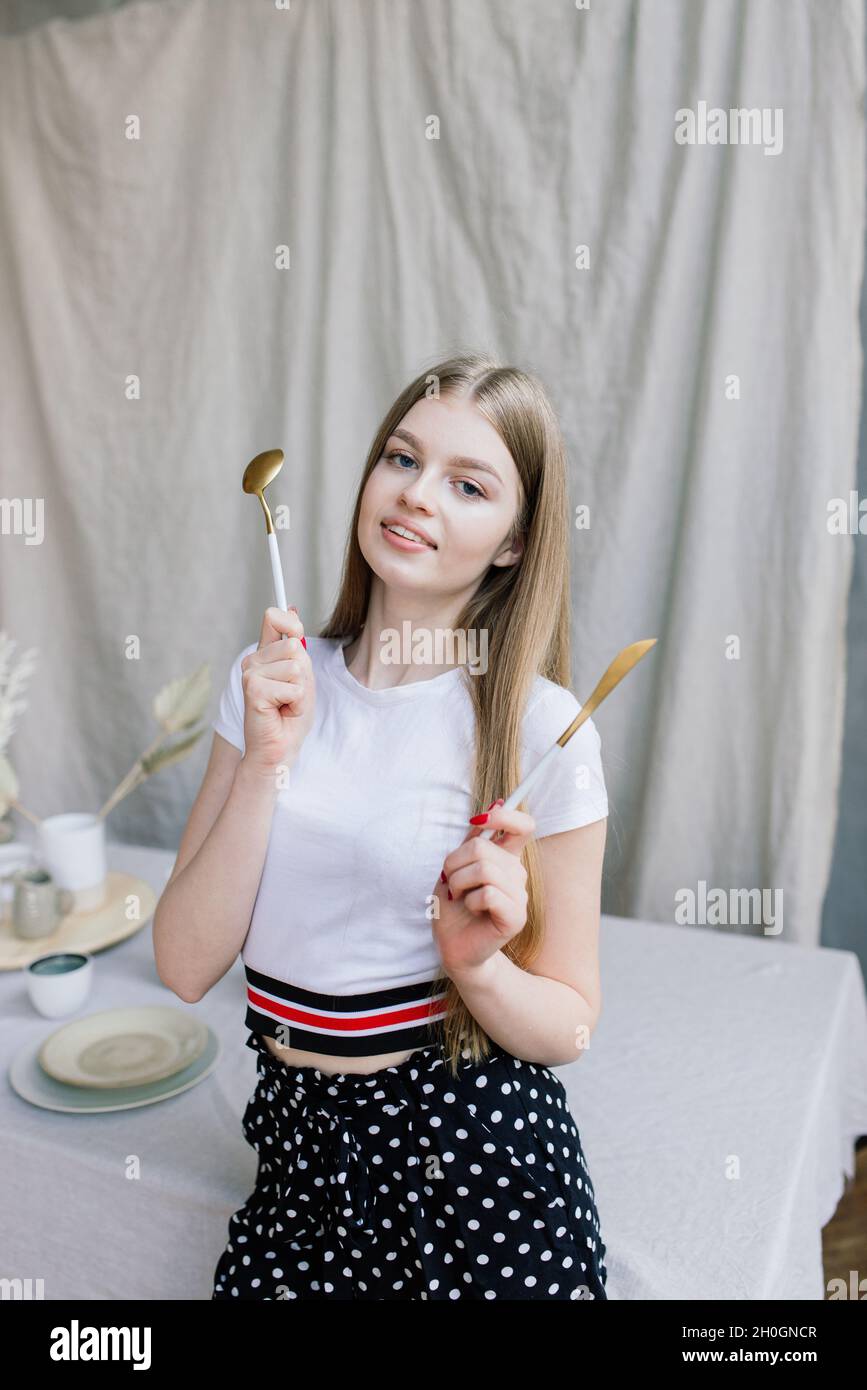 Young attractive woman relaxing on white sofa at the window at home ...