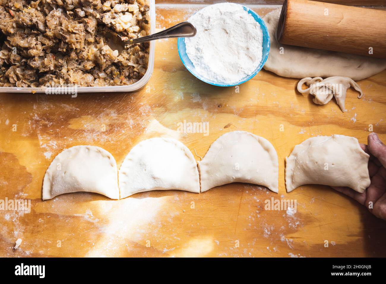 Woman's hands making empanadas. Ethnic food. Stock Photo