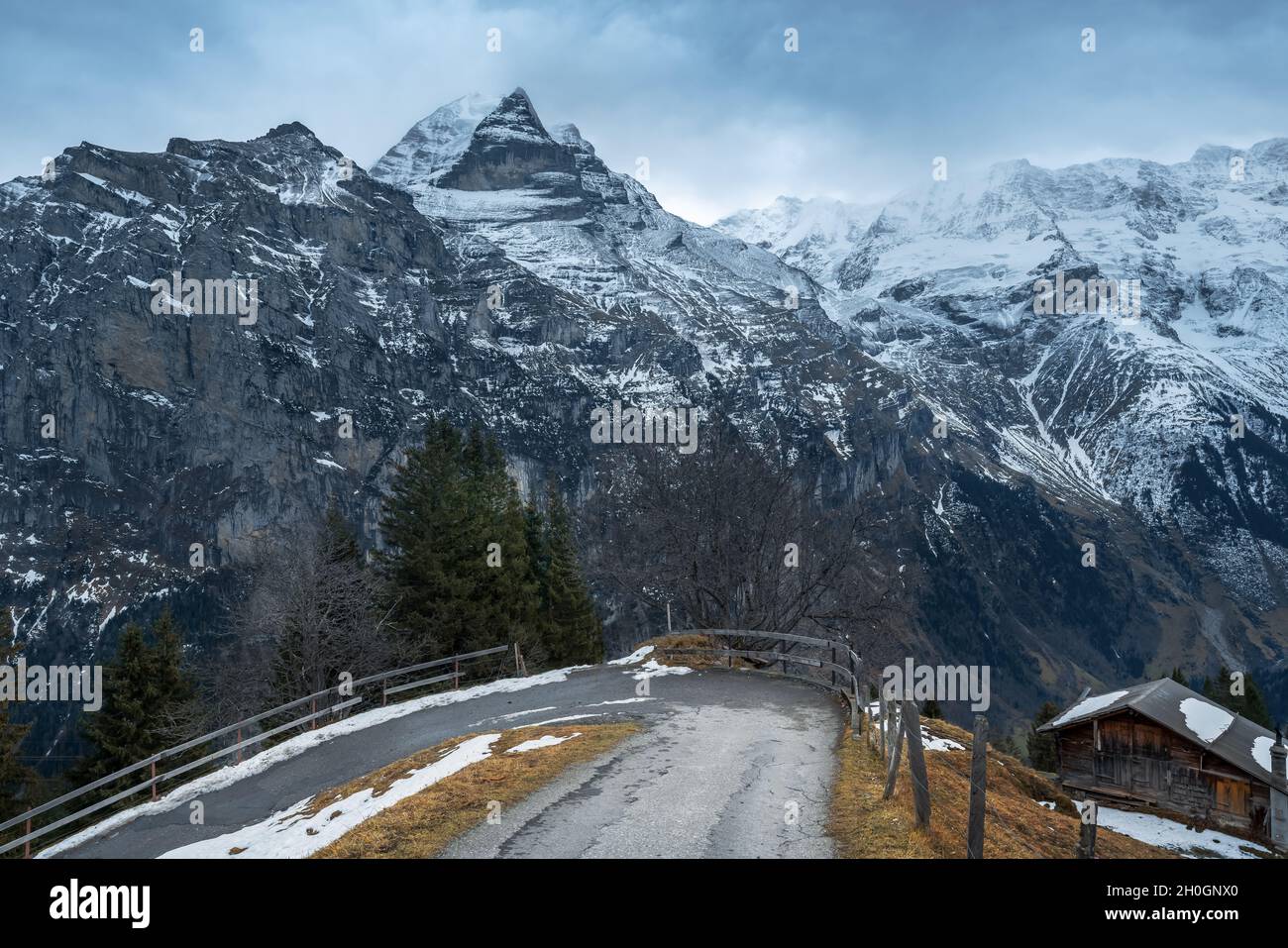 Road in Murren with Jungfrau Mountain on background - Silberhorn and Schwarz Monch parts - Murren, Switzerland Stock Photo