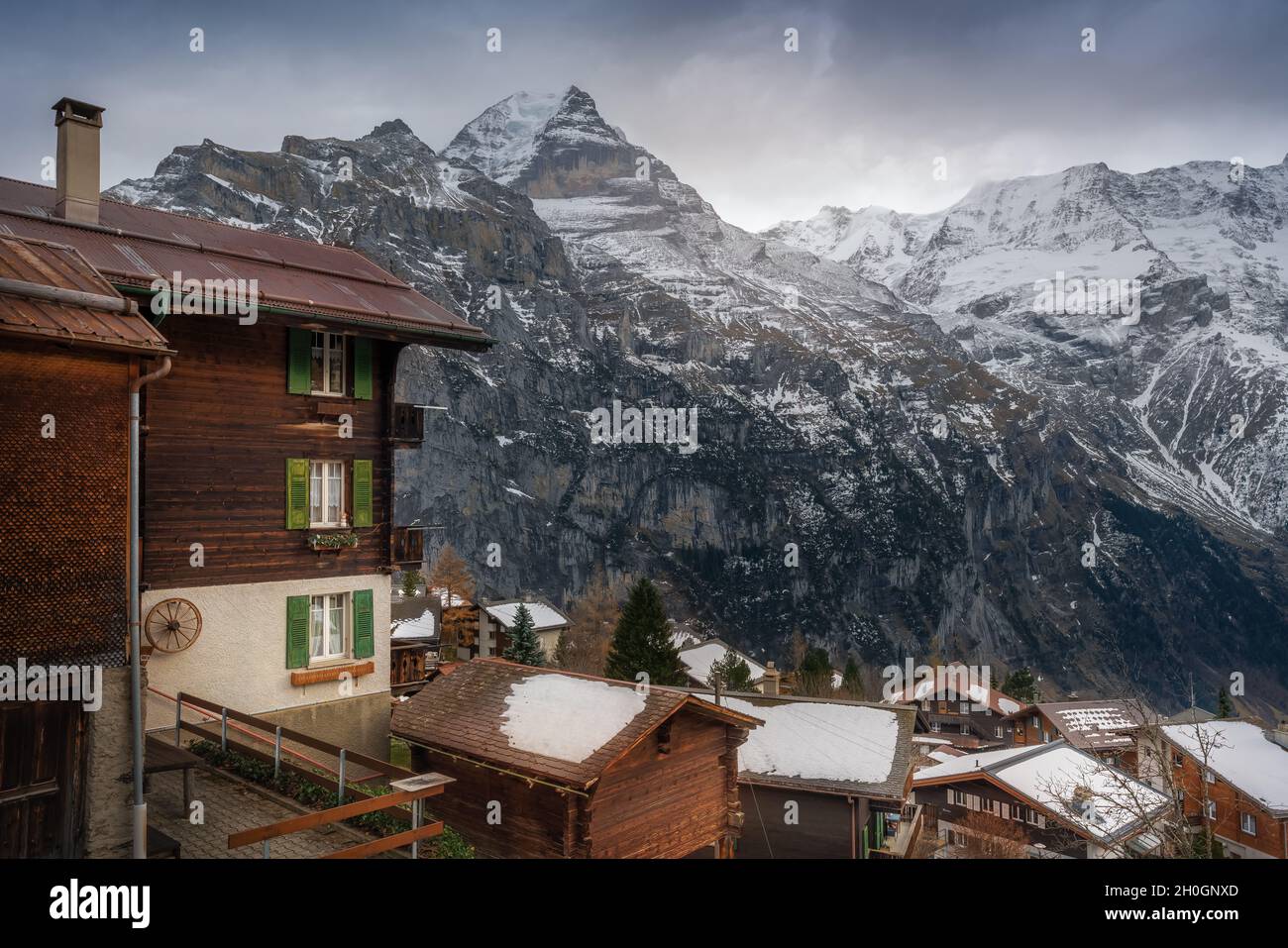 Houses at Murren Village with Jungfrau Mountain on background - Murren, Switzerland Stock Photo