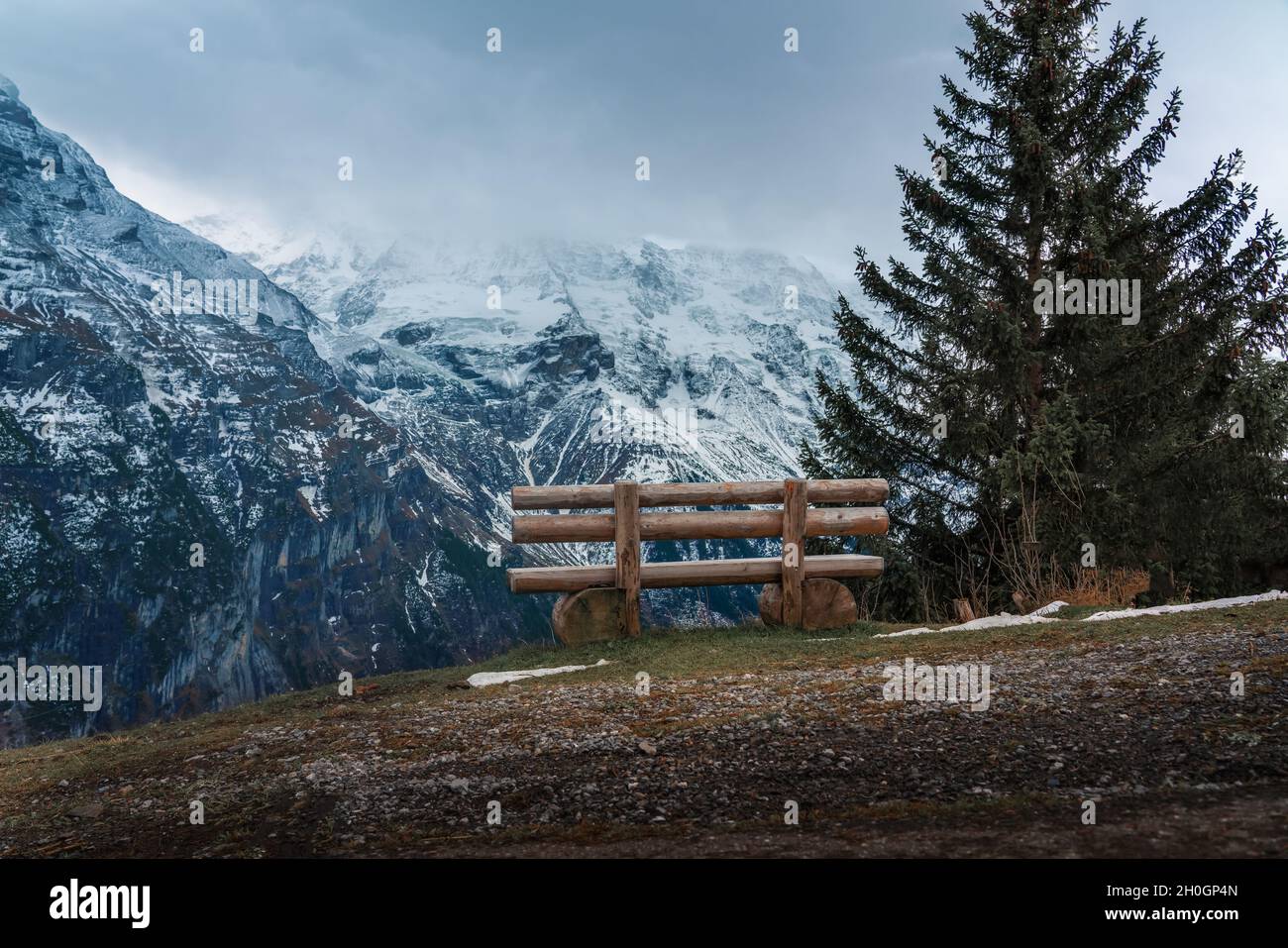 Wooden bench overlooking Alps Mountains - Murren, Switzerland Stock Photo