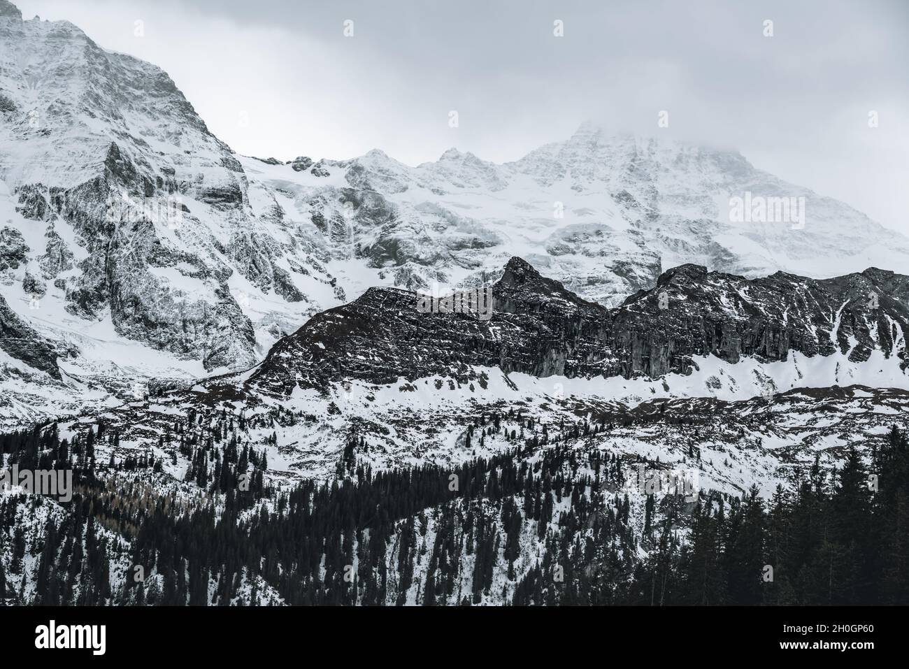 Bernese Alps Mountains with Grosshorn  e Breithorn peaks with a foggy haze - Murren, Switzerland Stock Photo