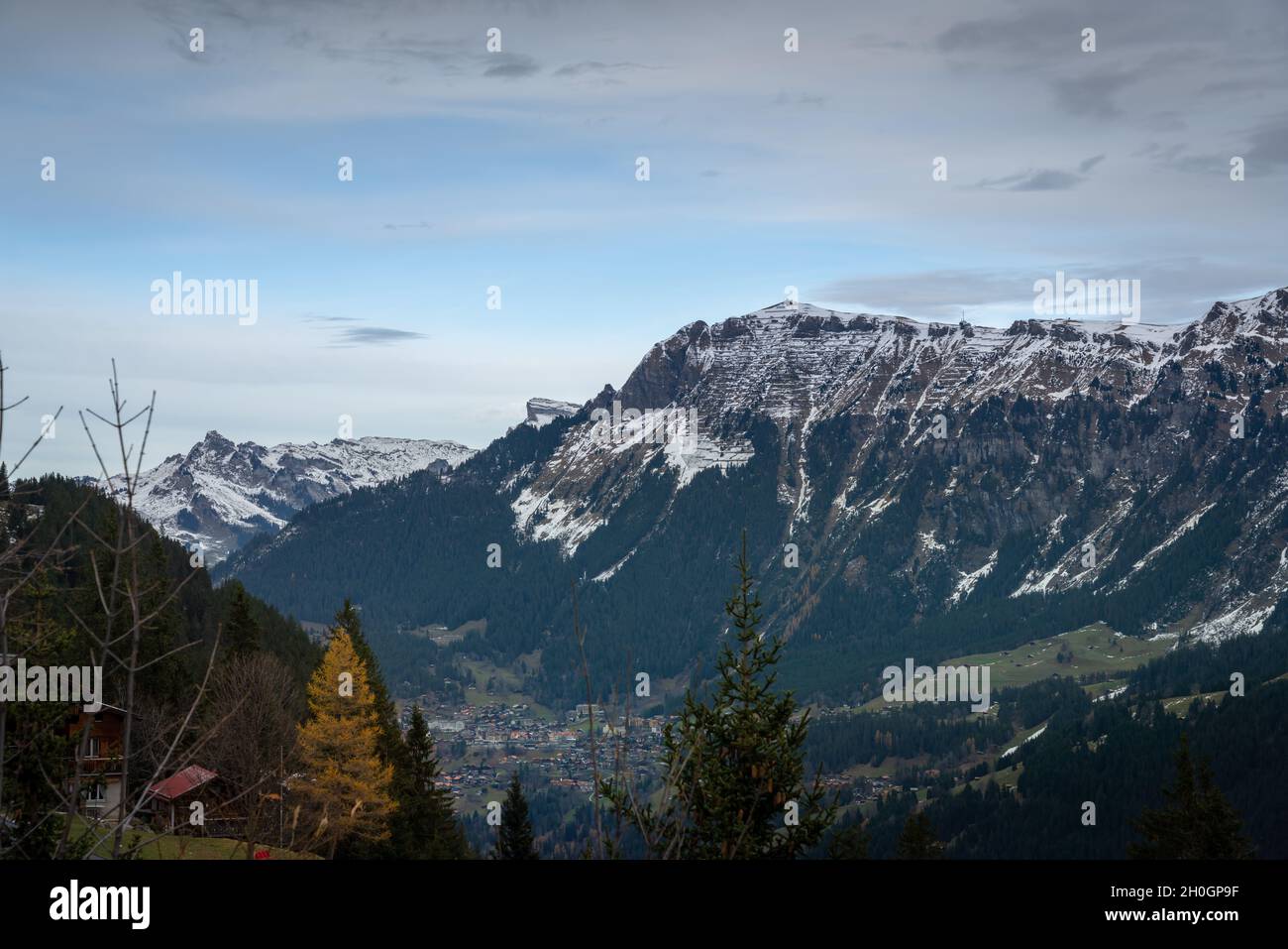 Mannlichen Mountain in the Bernese Alps stays above Wengen Village - Murren, Switzerland Stock Photo