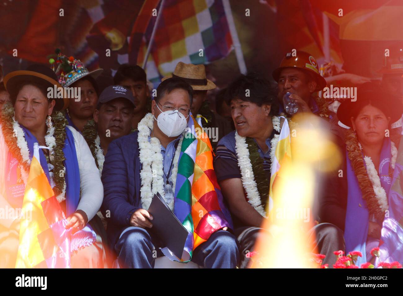 Cochabamba, Bolivia. 12th Oct, 2021. Evo Morales (r), leader of the Bolivian socialist party Movimiento al Socialismo (MAS), speaks at the so-called 'Wiphalazo' with the President of the Plurinational State of Bolivia, Luis Arce Catacora. Participants in the event honor the Wiphala, a flag and symbol of the indigenous people. The wiphala had been removed from a flagpole by right-wing activists on September 24 during an event celebrating the anniversary of the city of Santa Cruz. Credit: David Flores/dpa/Alamy Live News Stock Photo