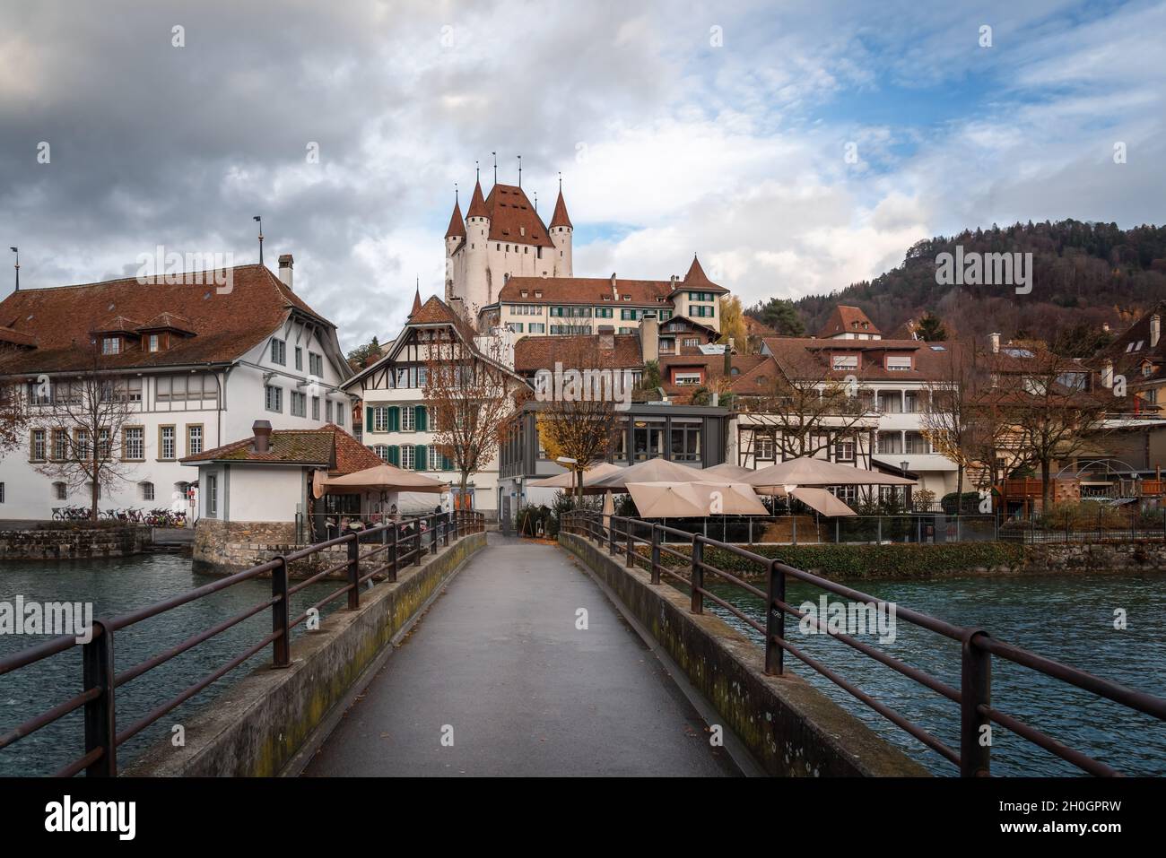 Bridge and view of Thun city with Thun Castle (Schlossberg Thun) on background - Thun, Switzerland Stock Photo