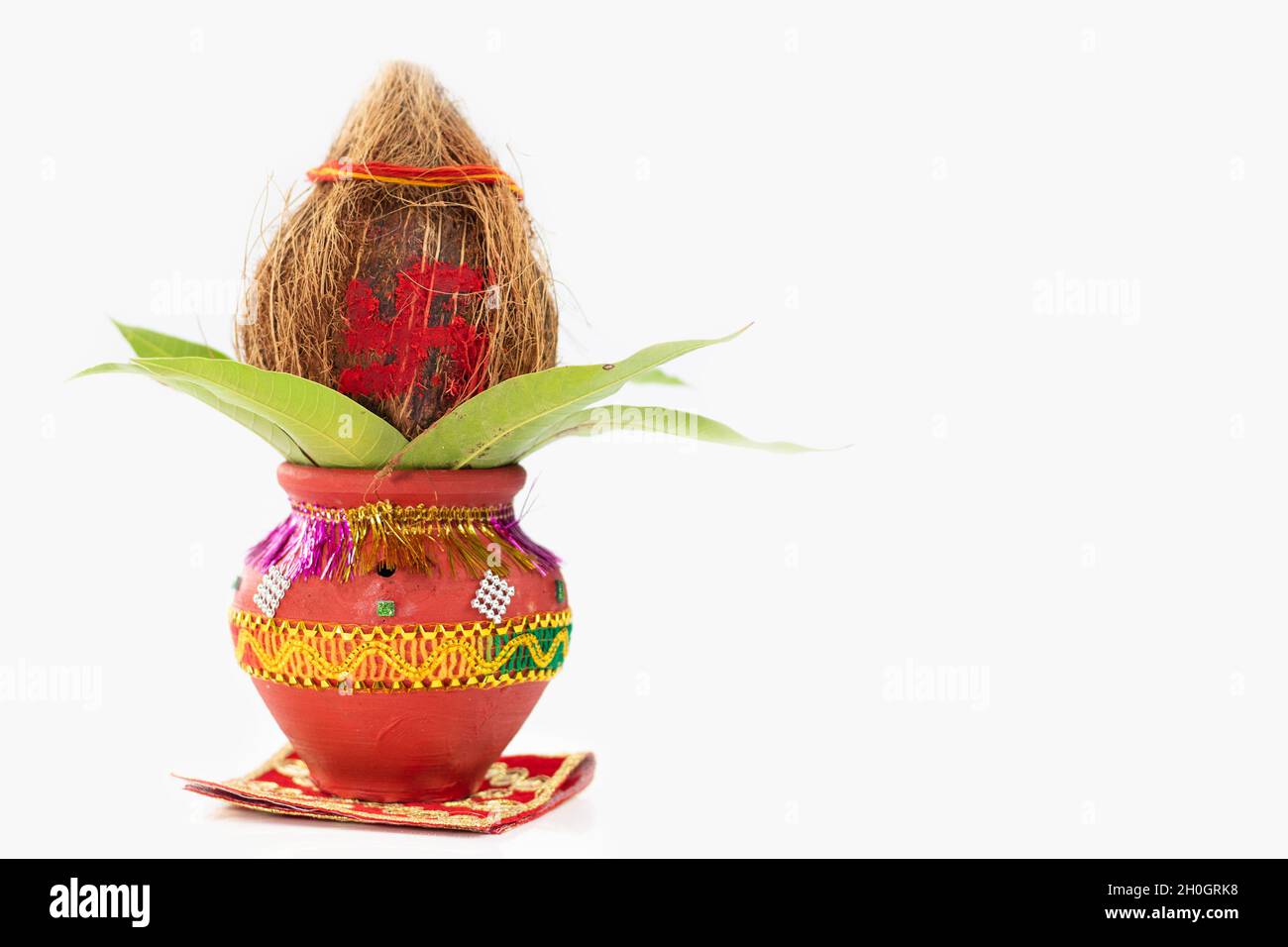 Pooja Kalash On Red Asan Decorated With Coconut, Mango Leaf Used In Navratri Pooja, Dussehra Puja, Karva Chauth, Teej, Ganesh Chaturthi Or Shubh Deepa Stock Photo