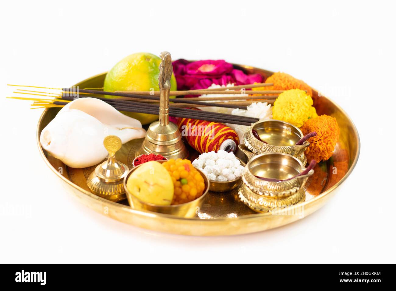 Decorated Golden Pooja Ki Thali Decorated With Mithai, Diya, Deep, Flowers, Genda Phool, Shankh, Roli, Kumkum, Agarbatti, Ghanti, Raksha, Moli. Theme Stock Photo
