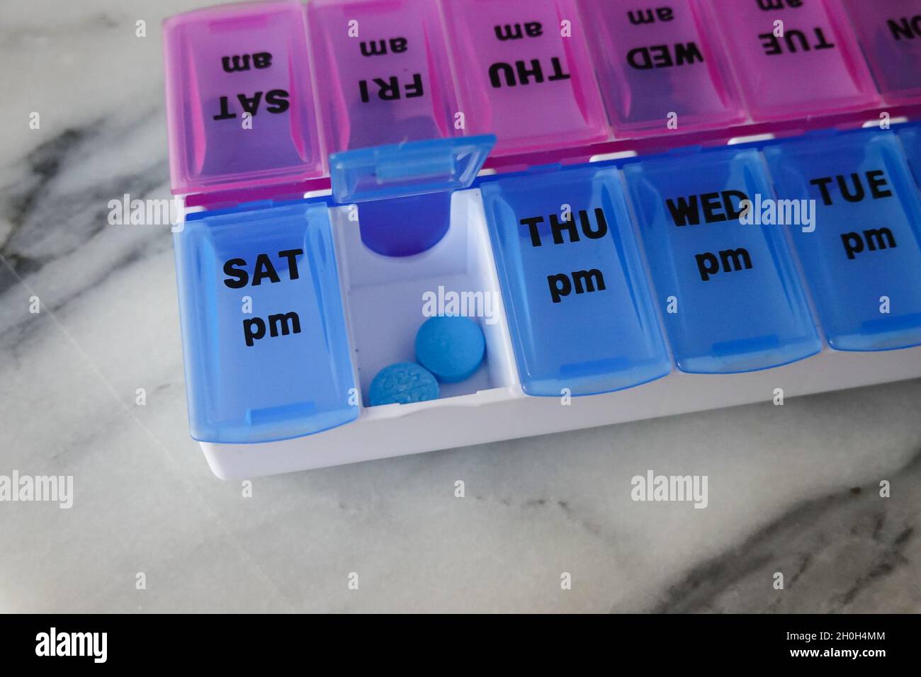 Weekly pill planner plastic box Stock Photo