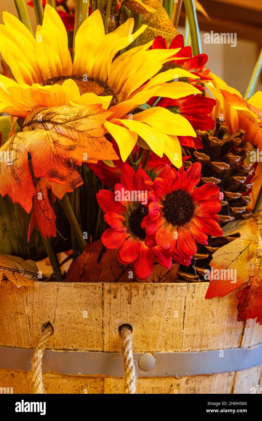 Using artificial leaves and flowers for an autumn display Stock Photo
