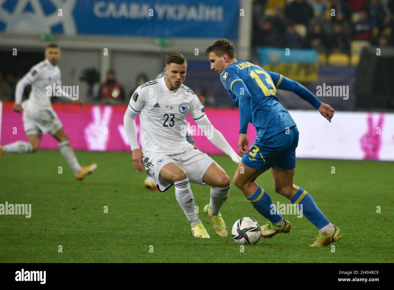 LVIV, UKRAINE - OCTOBER 12, 2021 - Players of the national team of Ukraine Illya Zabarnyi (R) and Bosnia and Herzegovina Ermedin Demirovic fight for the ball during the 2022 FIFA World Cup qualifying matchday 8 game which ended in a draw 1:1, Lviv, western Ukraine Stock Photo