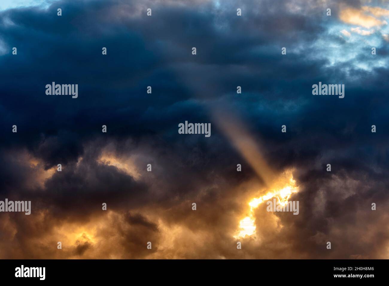 Sunbeam through gap in clouds, dramatic evening sky, Orkney Islands, Scotland, United Kingdom Stock Photo