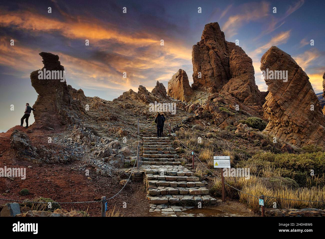Hikers at rock formation, bizarrely shaped towers of volcanic rock ...