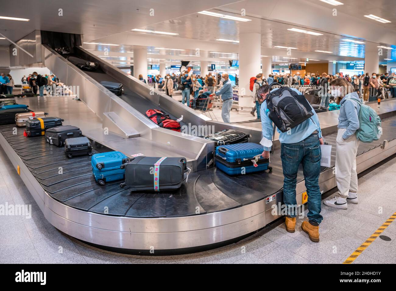 People waiting at baggage claim at an airport, Reykjavik Airport, Iceland Stock Photo