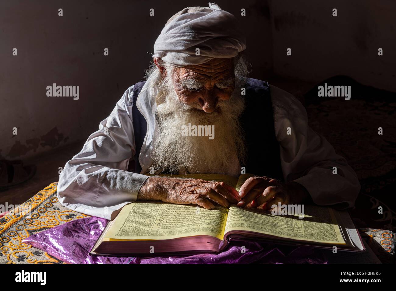 Sufi priest studying the holy Quran in the Shrine of Mawlana Abdur Rahman Jami, Herat's greatest 15th century poet, Herat, Afghanistan Stock Photo
